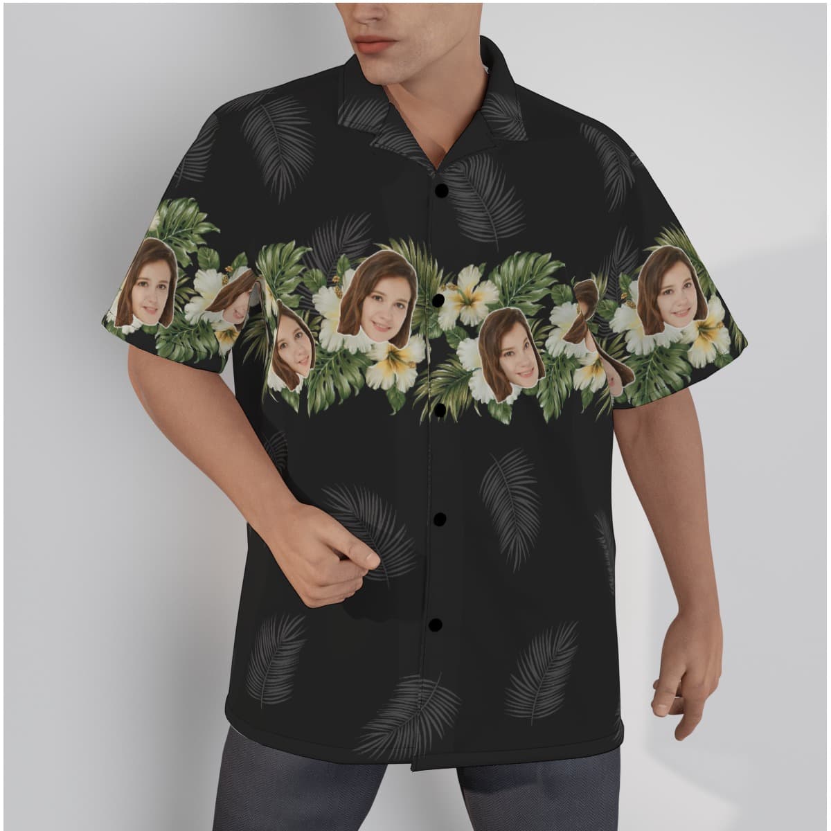 A Black Hawaiian shirt with palm tree leaves, tropical motifs with hibiscus and leaves all over the shirt, you can custom faces on the design