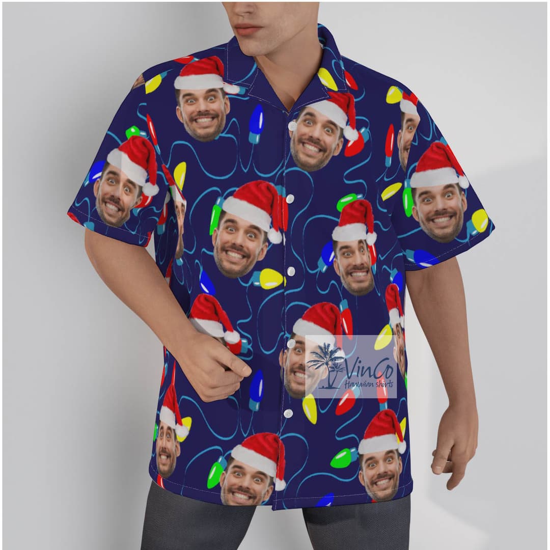 A short sleeve Hawaiian shirt with design of a bright blue background with vibrant Christmas lights bulbs.