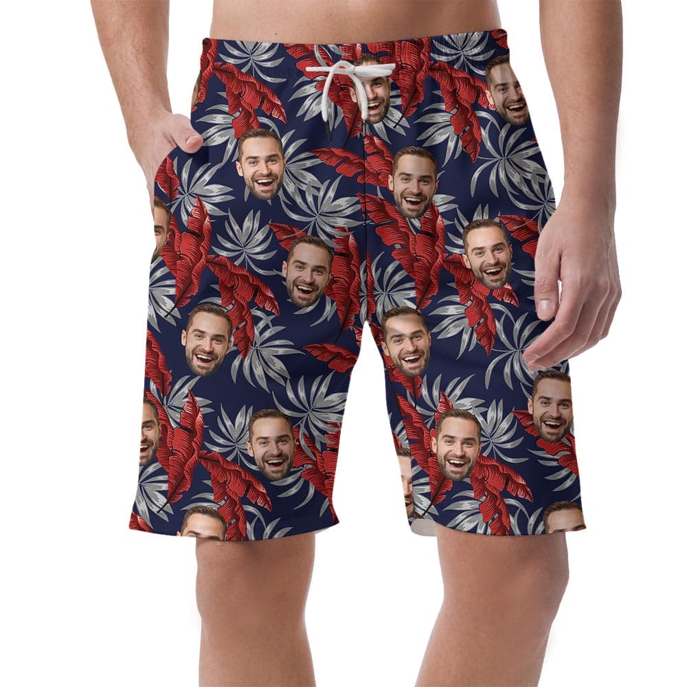 Men's Tropical Beach Shorts With 1-5 Faces has a navy background with tropical leaves and perfect for summer trips